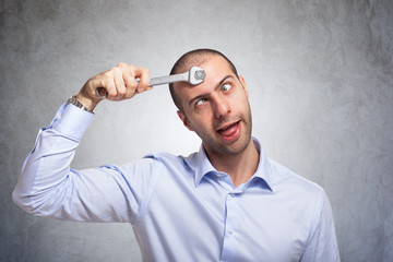 Man using a wrench to fix his brain