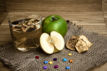 Apple juice with apples on wooden background