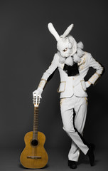 Rabbit Dj in white suit on color background with guitar in hands - 81121791