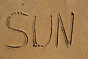 The word sun drawn in sand