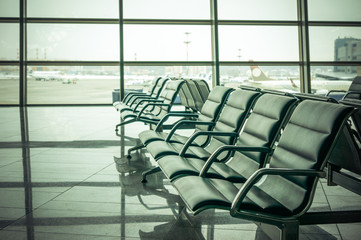 airport waiting area , seats and outside the window scene