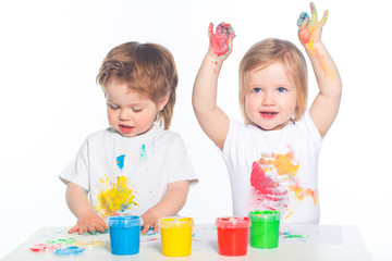 Fototapeta premium Little boy and girl playing with paints