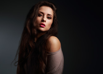 Sexy long hair woman with bright makeup on dark