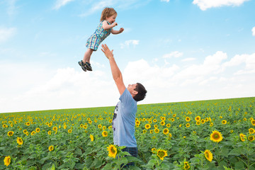 Father with son on the sunflower field