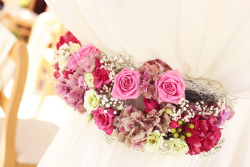 Beautifully decorated wedding flowers with chair