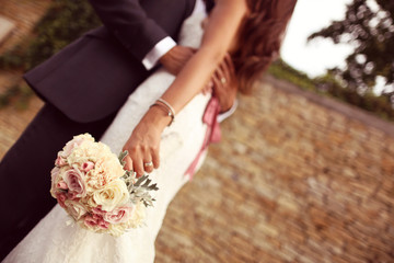 Groom embracing the bride