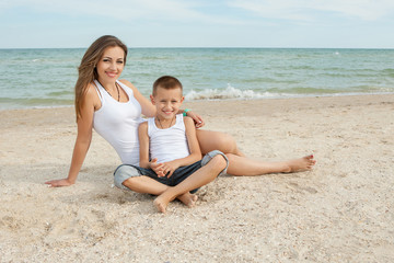 Mother and her son having fun on the beach
