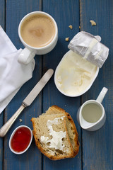 coffee with milk, bread, jam and cheese