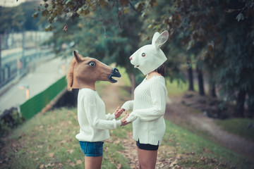 Obraz premium horse and rabbit mask young couple beautiful women girls