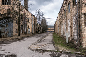 Old abandoned industrial street view with brick facades