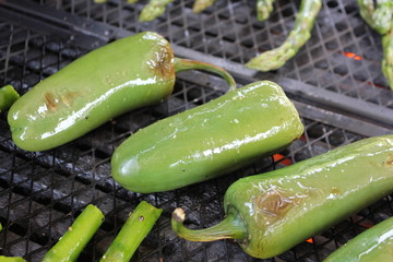 Grilling Jalapenos and asparagus on a barbecue