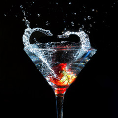 Martini glass with splashes and strawberry