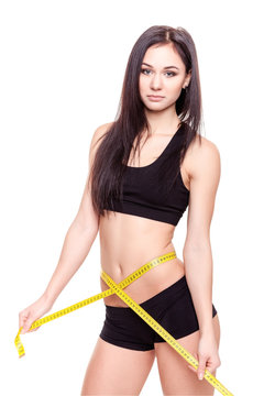 Young Woman measuring her waist - Stock Image