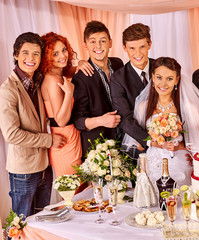 Group people at wedding table.