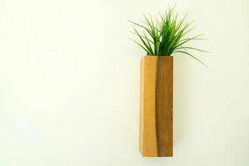 Wooden flowerpot hung on the white wall