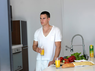 man cooking at home preparing salad in kitchen