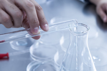 State that pouring a liquid of a test tube