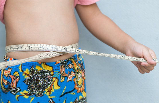 Little girl measuring her stomach