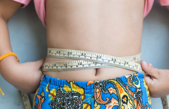 Little girl measuring her stomach