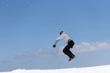 Naklejka na ściany i meble Snowboarder jumps in Snow Park