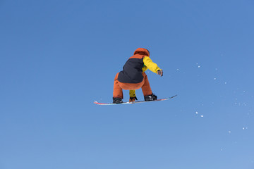 Snowboarder jumps in Snow Park