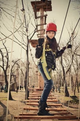 Tuinposter tinted image teen girl going on suspension way and looking at ca © Tanya Rusanova