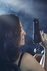 Enigmatic and mysterious woman with gun