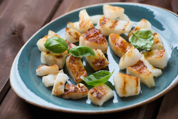 Sliced and grilled pineapple with basil, selective focus