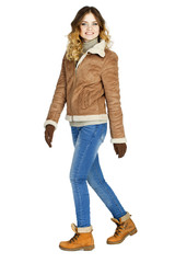 Young beautiful girl in a leather sheepskin coat and blue jeans