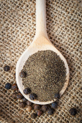 black pepper on the wooden spoon