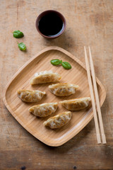 Japanese traditional gyoza dumplings with soy sauce, above view