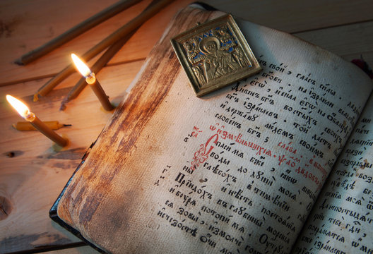 Christian still life with burning candles and old Psalter