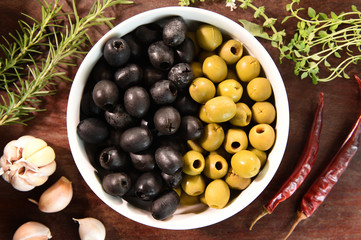 green and black olives in white bowl ingredients for pizza