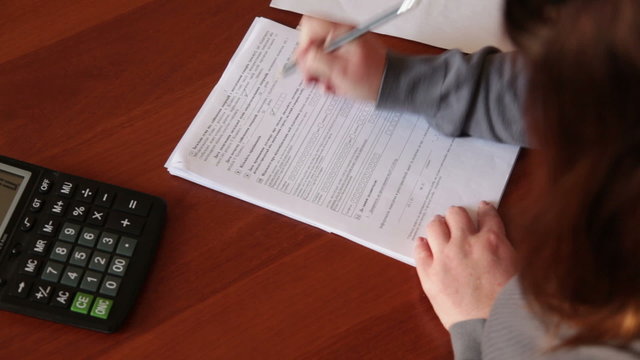 Female hand fills out a form