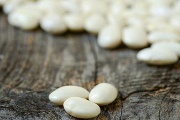 Fototapeta na wymiar Beans isolated on a wooden texture