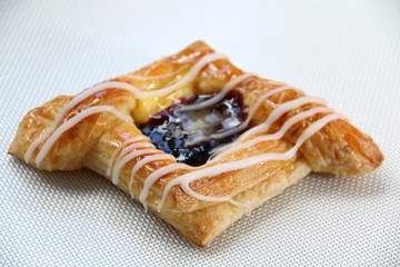 Danish pastry with blueberries jam  on white..