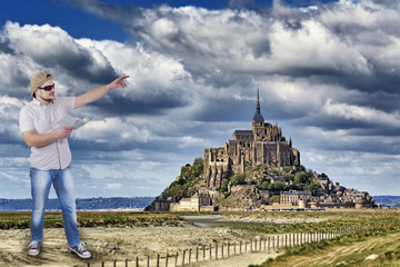Man with guide book in a hand with Mont Saint-Michel, Lower