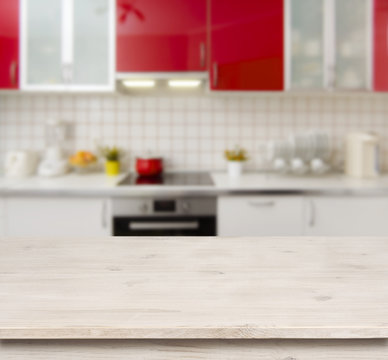 Wooden table on red modern kitchen bench interior background