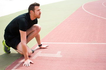 man ready to run on the running track