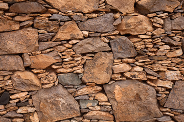 Fuerteventura, dry stone wall of local red rock