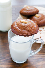 Almond cookies with a glass of milk and more cookies in the back