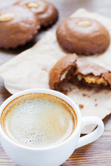 cup of coffee and almond cookies in the back