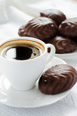 cup of black coffee and marshmallows in chocolate