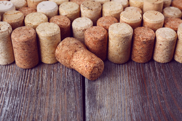 Wine corks on rustic wooden planks background