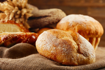 Different bread with ears on sackcloth background