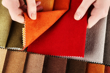 Woman chooses scraps of colored tissue on table close up