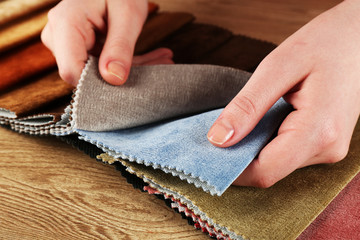 Woman chooses scraps of colored tissue on table close up