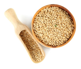 Sesame in wooden bowl, isolated on white