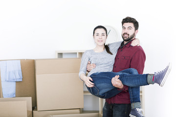 Fototapeta na wymiar beautiful young couple unpacking happy in new home