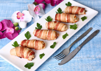 Chicken rolls stuffed with vegetables wrapped in bacon
